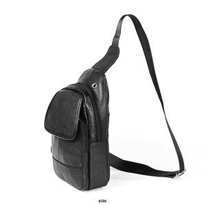 Side view detail of a black leather chest bag showing texture and earphone hole