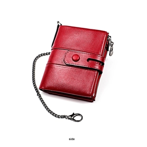 Side view of red leather wallet featuring double zippers and anti-theft metal chain link