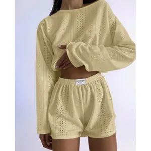 Detailed close-up of light yellow knit set featuring hollow texture and elastic waist shorts