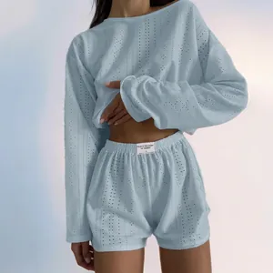 Close-up of light blue two-piece set featuring knit texture and waist label detail