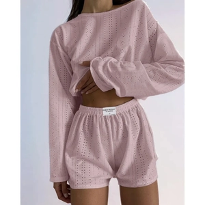 Women pink two-piece set featuring long sleeve top and high-waisted shorts with eyelet texture