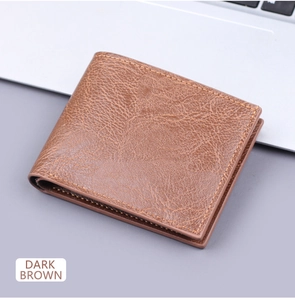 Detail of dark brown bifold wallet with lychee leather texture and contrast stitching
