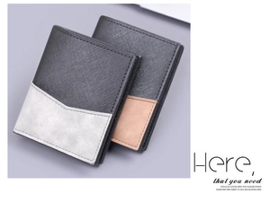 Detailed view of men's short bifold wallet with contrast V-shaped stitching and textured leather