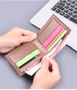 Detailed interior of a brown leather bifold wallet with card slots and zipper pocket
