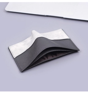 Detailed view of bicolor vertical wallet with textured crosshatch leather and card slots