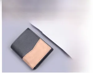 Detailed view of the bifold men's wallet showing black crossgrain and brown matte leather