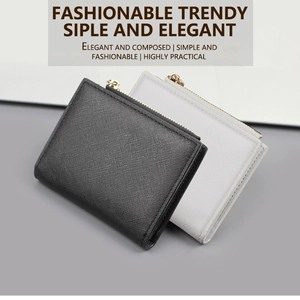 Detail of slim black and white Saffiano leather wallets with gold zippers and card slots