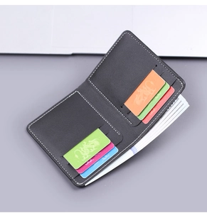 Close-up of black vintage men's wallet showing multiple card slots and fine white stitching