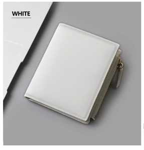 Close-up of white Saffiano leather wallet with silver zipper on a grey desk background