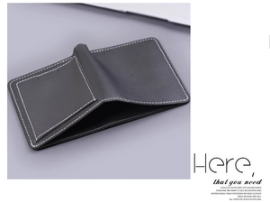 Detail view of black leather card holder wallet with distinct white contrast stitching