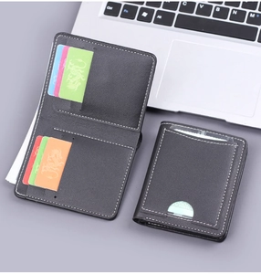 Close-up of black leather wallet with white stitching showing card slots and ID window
