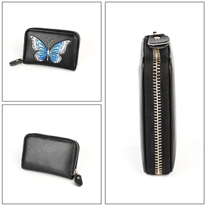 Detail of leather card holder with blue butterfly print and golden zipper closure