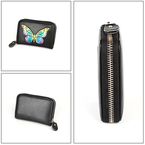 Detail of black leather card holder featuring embossed rainbow butterfly and metal zipper