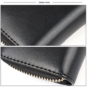 Close-up of black lychee grain leather wallet showing fine stitching and metal zipper