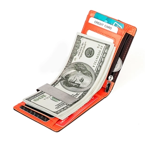 Macro view of orange leather bifold wallet with silver money clip and credit card slots