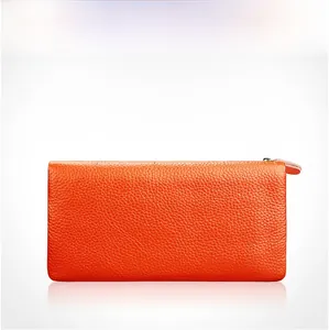 Detailed view of orange pebbled leather wallet with silver metal zipper closure