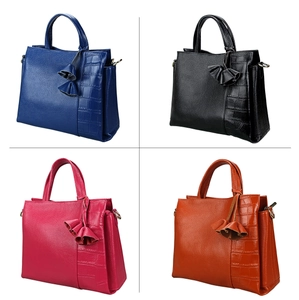 Detail of four colorful leather tote bags featuring litchi and crocodile texture mix