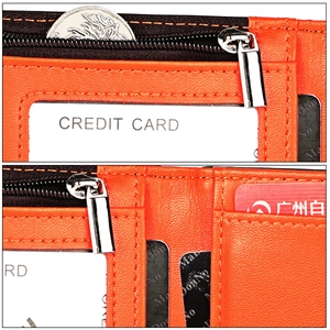 Macro shot of orange leather wallet interior featuring multiple card slots and zipper pocket