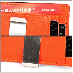 Detail view of orange leather money clip and card slots with lychee pattern