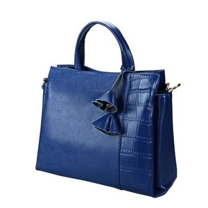 Detail of dark blue leather handbag with pebble grain and crocodile pattern stitching