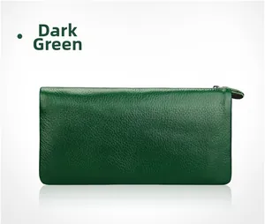 Detail of dark green leather wallet showing high-quality lychee grain and metal zipper