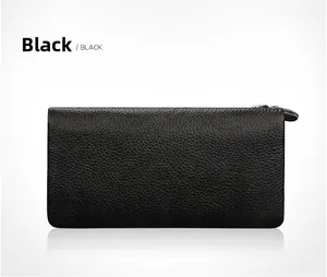 Detailed macro view of black top-grain leather texture on long zip wallet with silver zipper