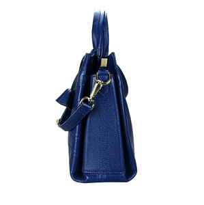 Detail of navy blue pebble leather side view and gold metal hardware on handbag
