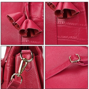 Detailed views of red leather handbag showing lychee texture, tassel, and gold hardware