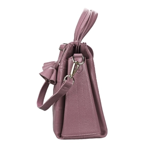 Detail of pink pebbled leather bag with decorative bow and gold metal hardware