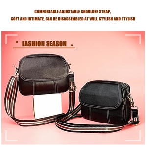 Detail of leather crossbody bags with white stitching and striped canvas straps