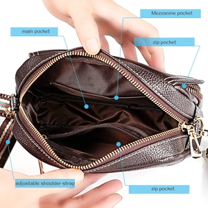Detailed view of the brown leather bag interior with main, mezzanine and zip pockets