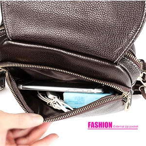Detail of genuine leather shoulder bag showing external zip pocket for phone storage