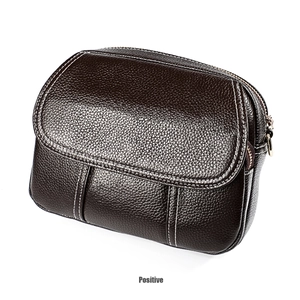 Macro detail of dark brown pebble leather bag featuring white contrast stitching and texture