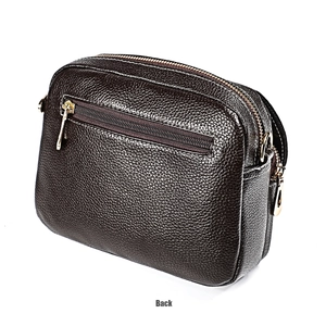 Detailed back view of a black pebble leather crossbody bag with a gold zipper pocket
