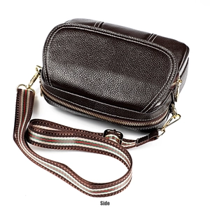 Detailed macro view of dark brown pebbled leather texture with white contrast stitching