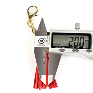 Detail showing measurement of 2mm leather tassel width on red keychain with caliper
