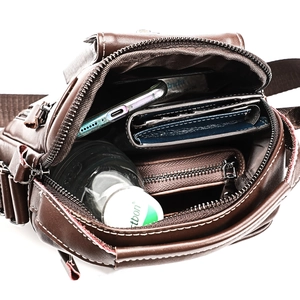 Detailed interior of a brown leather messenger bag showing multiple storage compartments