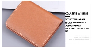 Detail of brown leather wallet featuring contrast stitching and natural grain texture