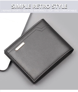 Macro shot of black pebbled leather wallet with L-shaped stitching and golden logo plate