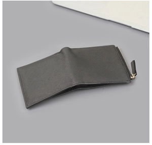 Close-up of black cross-grain texture on men's vertical wallet with metal zipper