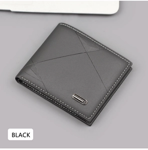 Detail of a black men's bifold leather wallet with asymmetric geometric stitching and metal trim