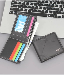 Detail view of men's short leather wallet with card slots and bill compartment