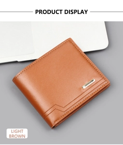 Detail of light brown bifold leather wallet with golden metal trim and wavy stitching