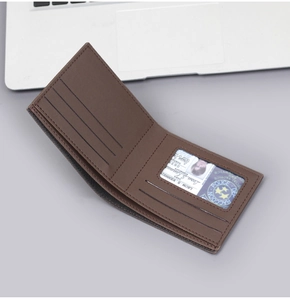 Detailed interior of brown bifold wallet showing card slots and transparent ID window