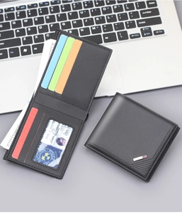 Detail of black bifold wallet showing colorful card slots and metal logo badge