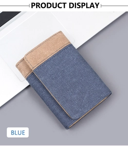 Detailed close-up of blue canvas tri-fold wallet with khaki trim on a desk