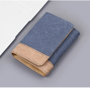 Detail view of tri-fold denim wallet with contrast stitching and durable canvas texture