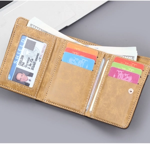 Detailed view of brown tri-fold wallet showing multiple card slots and banknote compartment