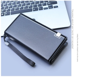 Macro detail of black grained leather business clutch with silver metal accent and wristlet