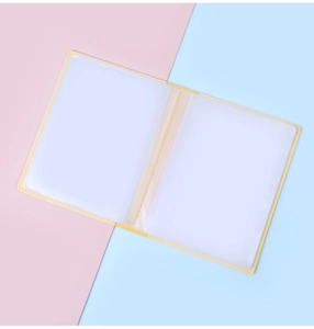 Detail view of the yellow passport holder's interior showing transparent card slots
